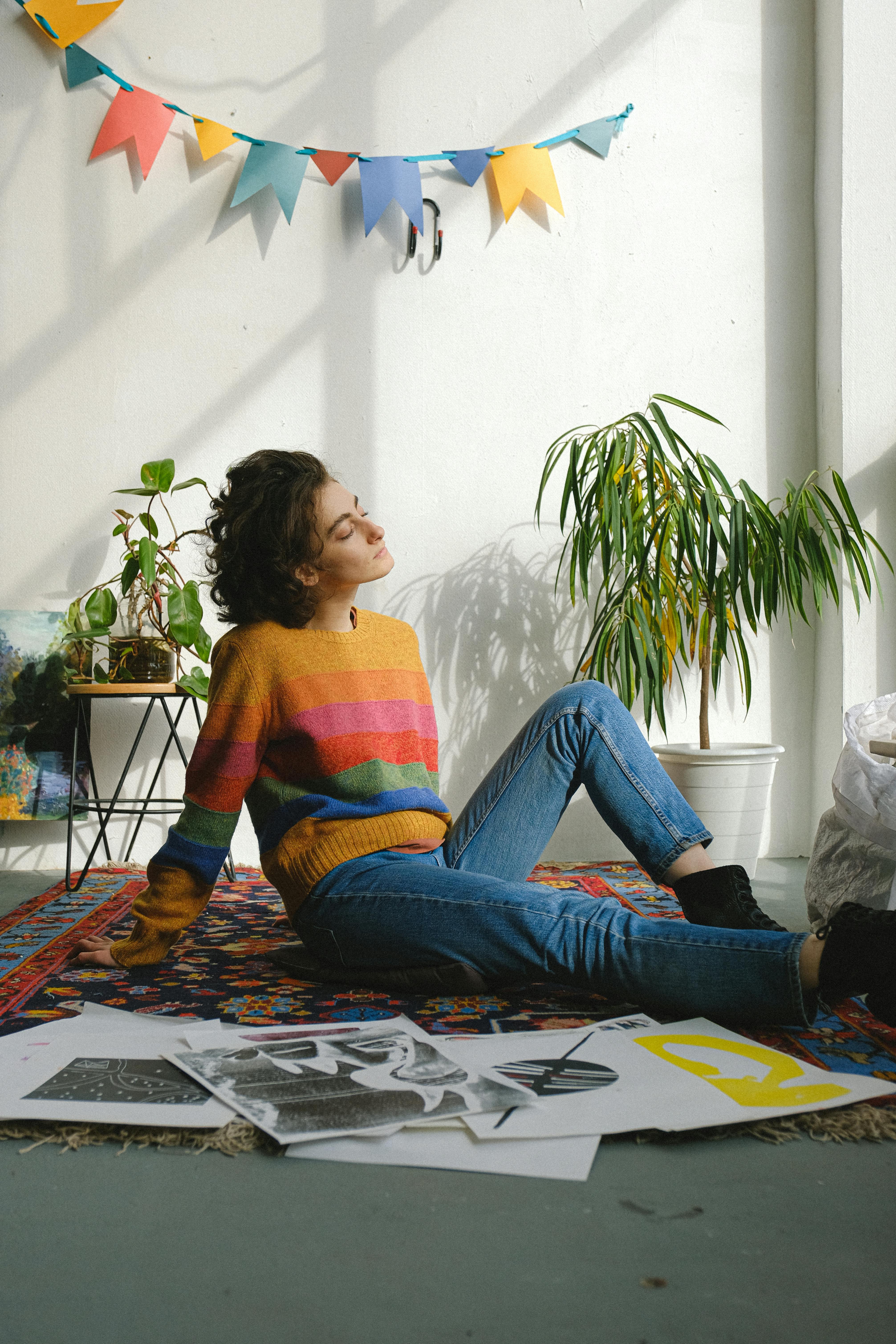 dreamy young artist having rest sitting on floor