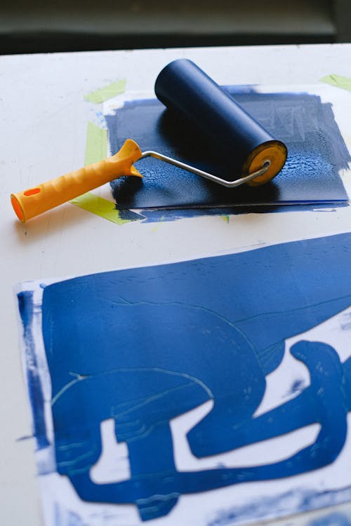 Paint roller and picture on table in craft shop