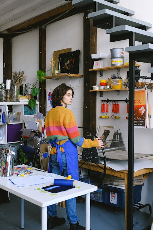 Artist working in modern workshop with printing machine