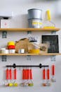 Tools and colours on shelves in painter workplace