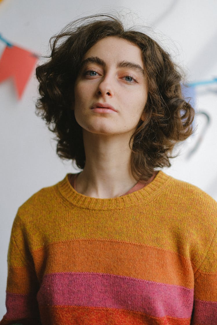 Young Dreamy Woman In Colourful Jumper