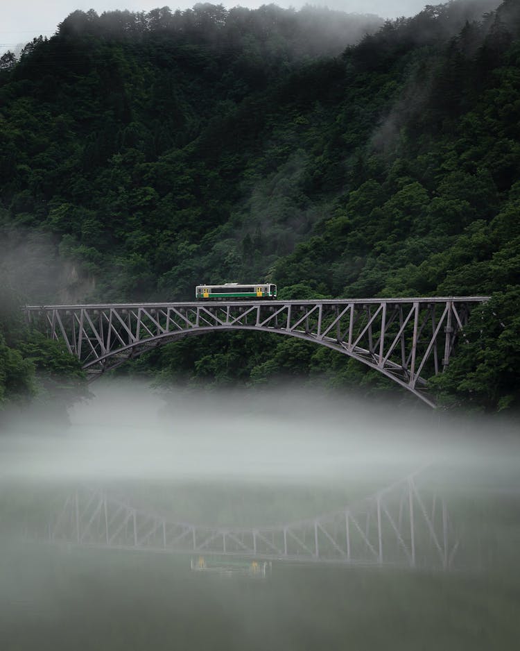 Railway Bridge Over River In Mountain Valley