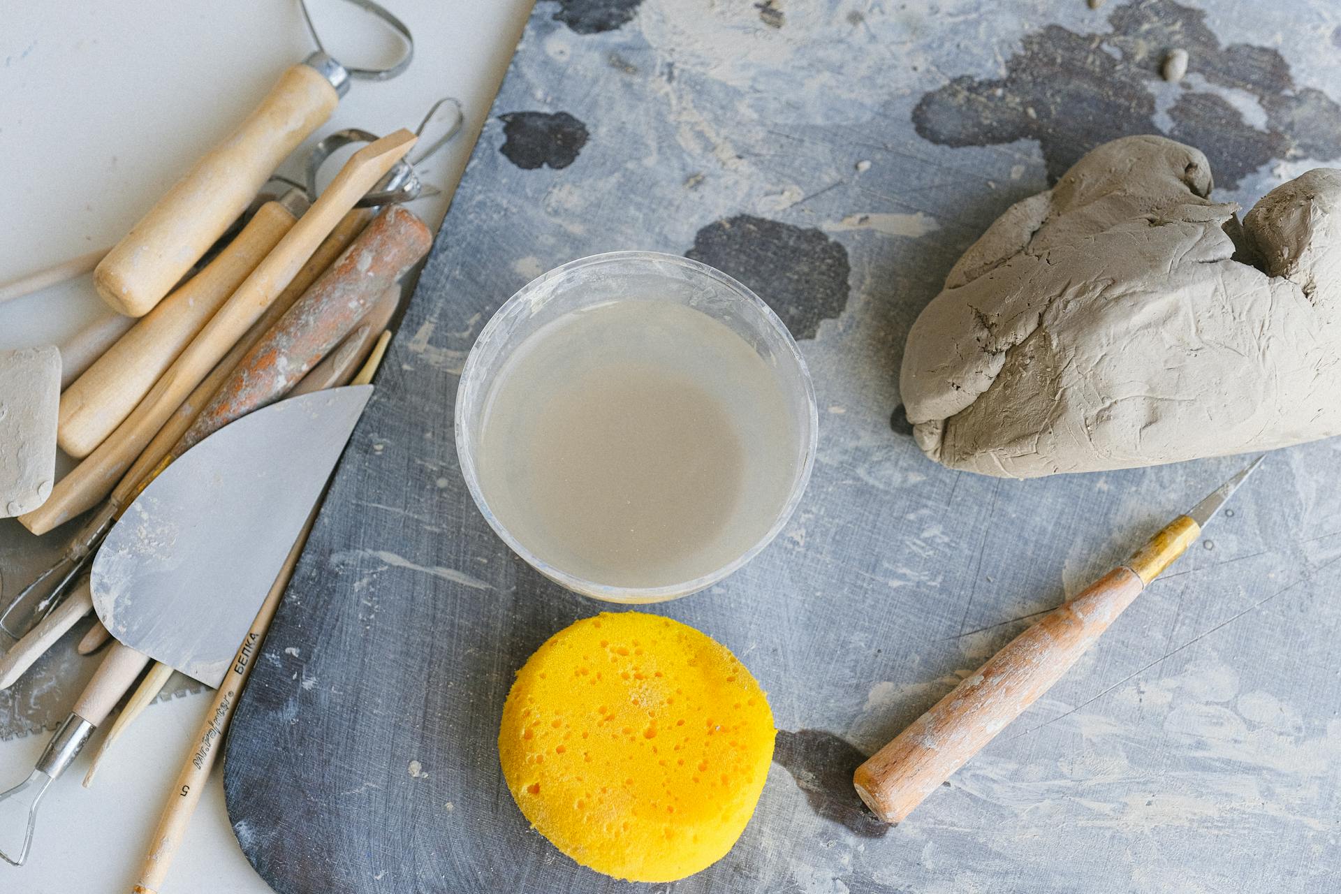 Tools and bowl of water prepared for clay modeling