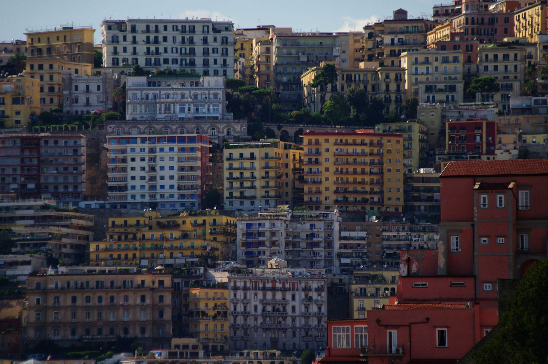 A vibrant view of colorful apartment buildings in Naples, showcasing urban architecture.