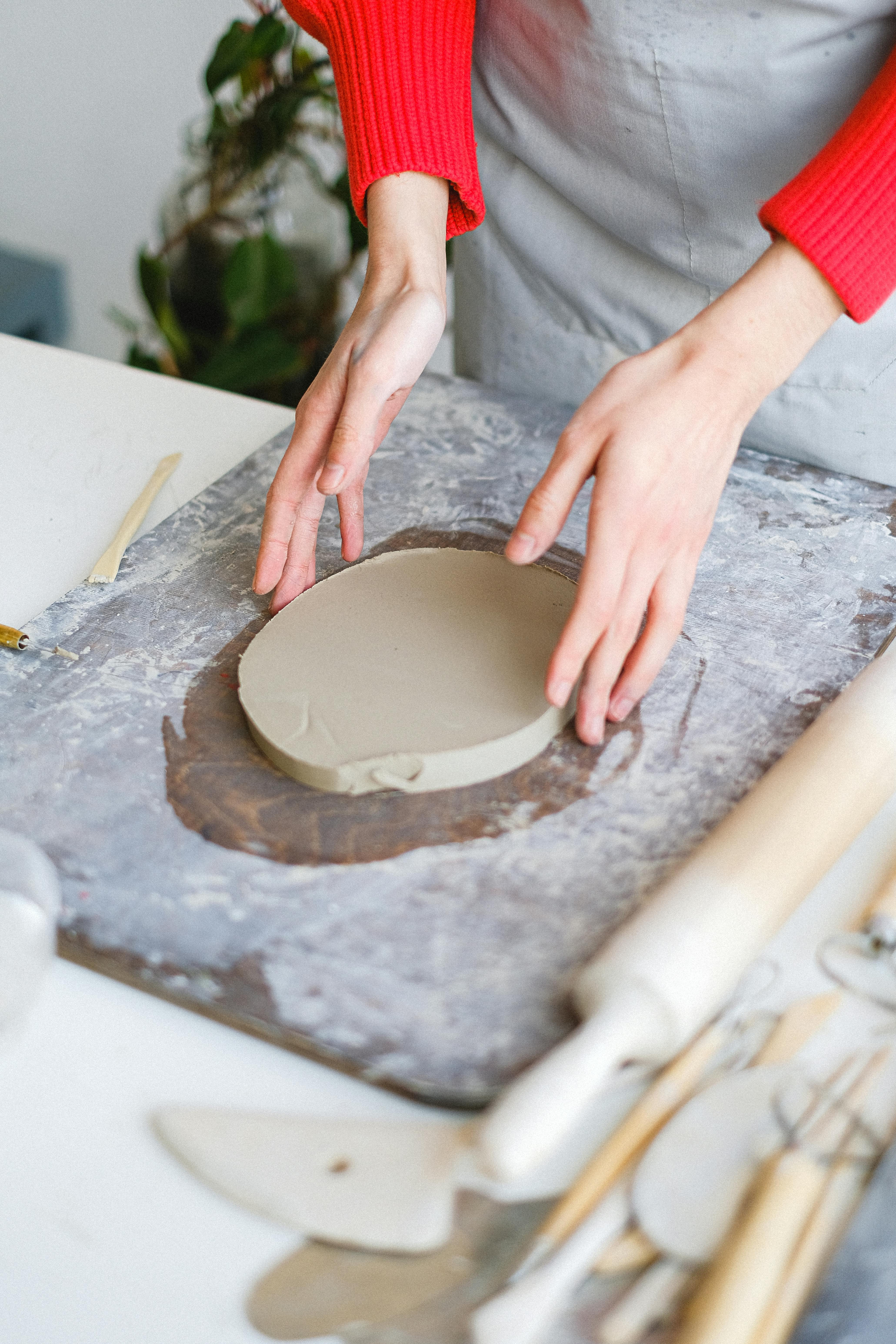 crop woman working with clay