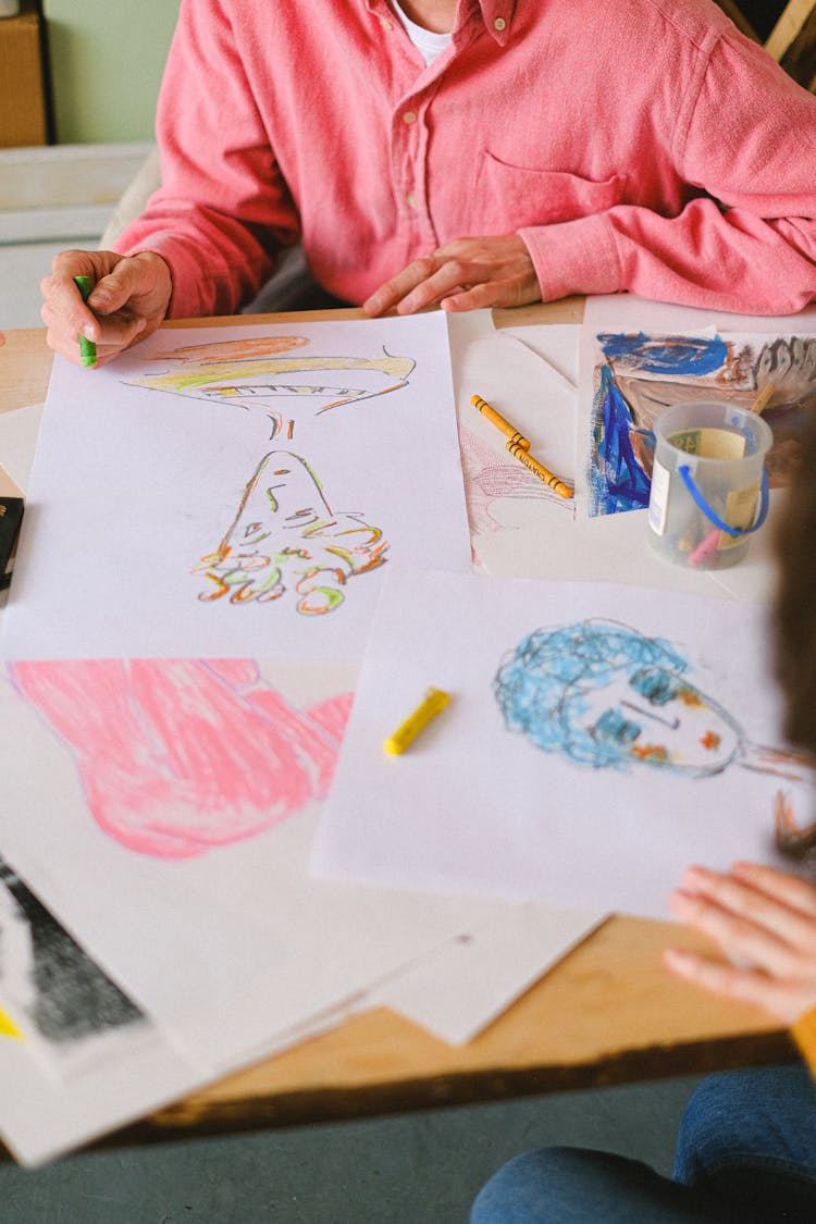 Crop Artists Drawing With Crayons In Studio