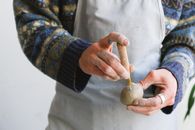 Crop man with tool and clay ball