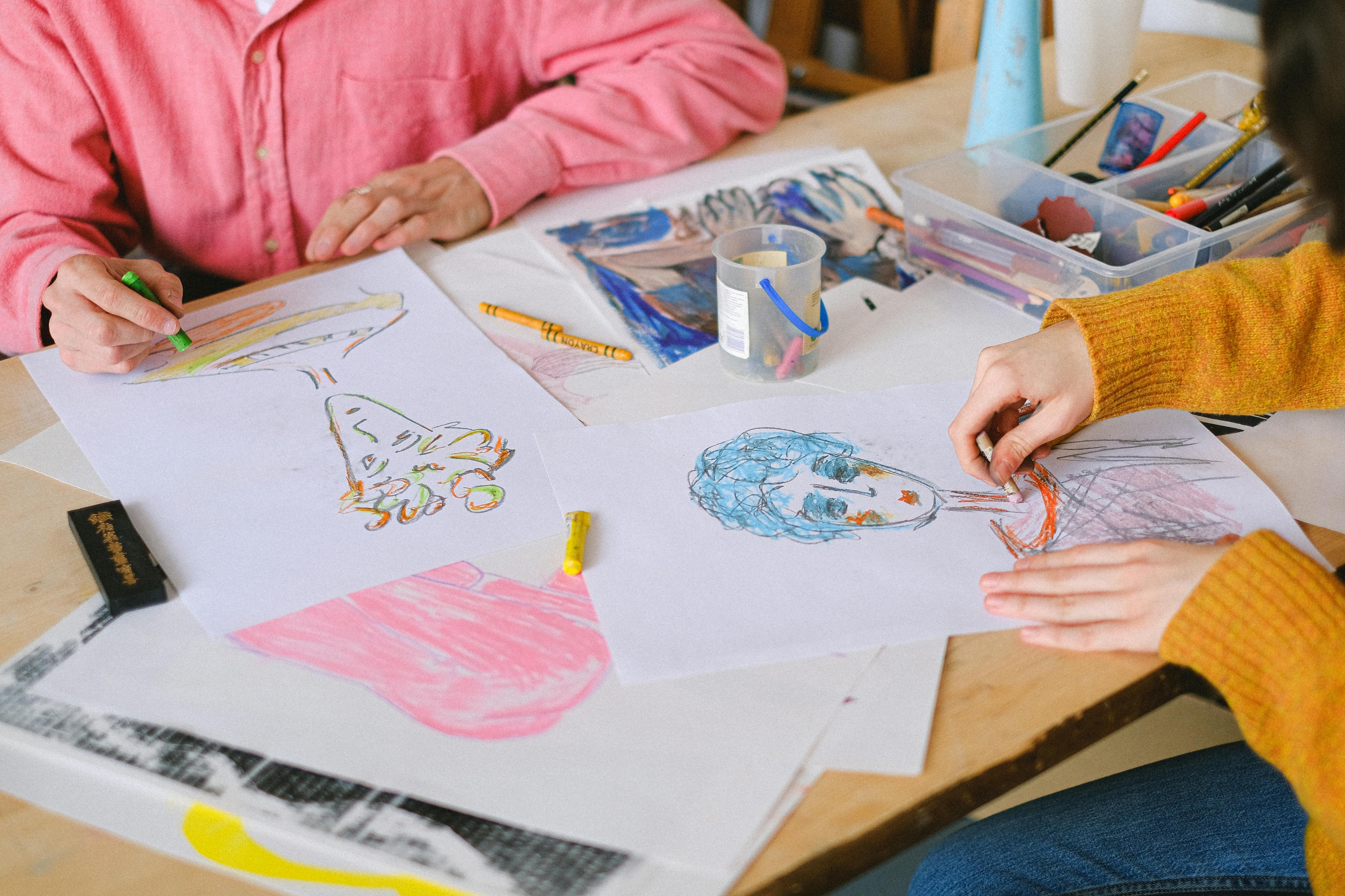 crop painters drawing on papers