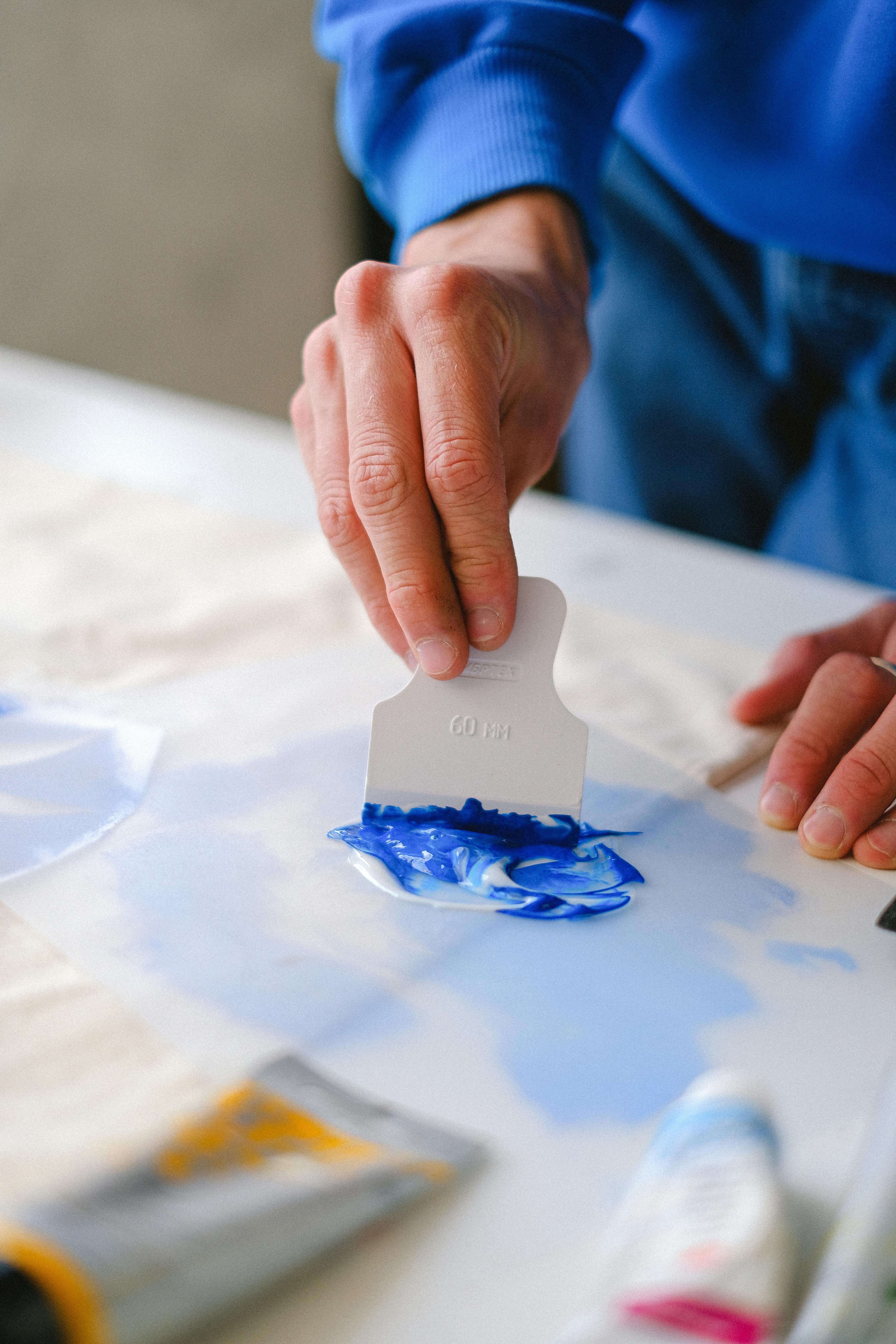 crop artist preparing paints on table