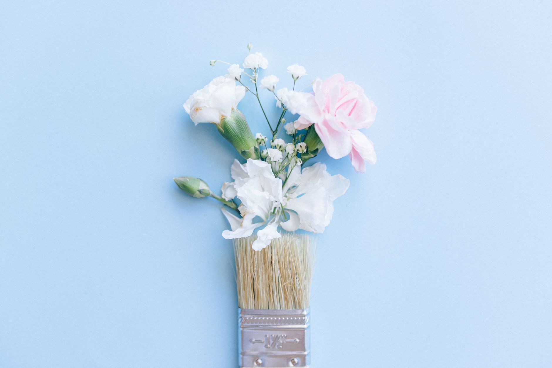 Blooming Flowers and Paintbrush on Light Blue Background