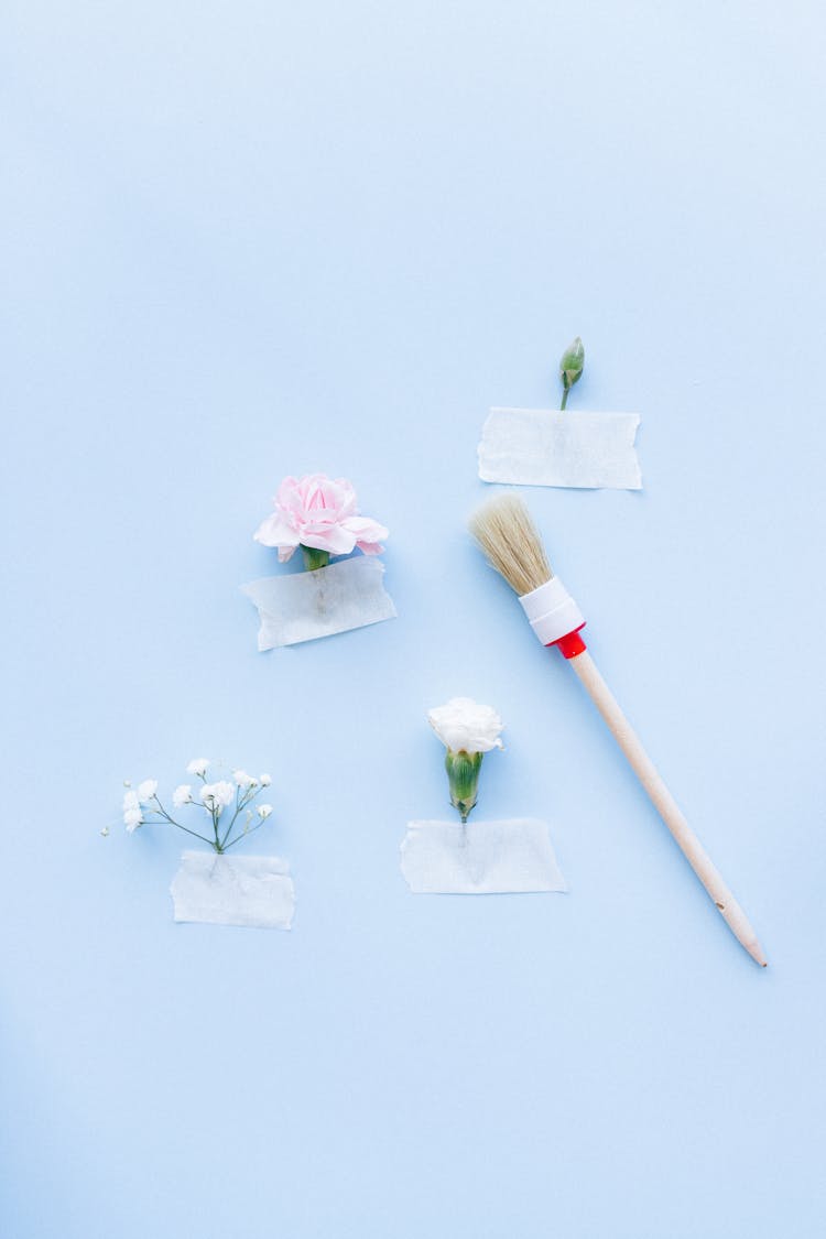 Close-Up Shot Of A Paint Brush And Taped Flowers