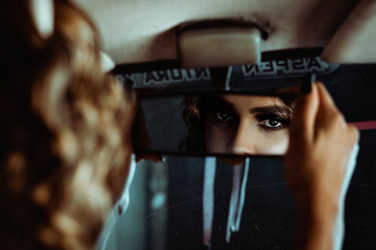 Person Looking At The Rear-View Mirror