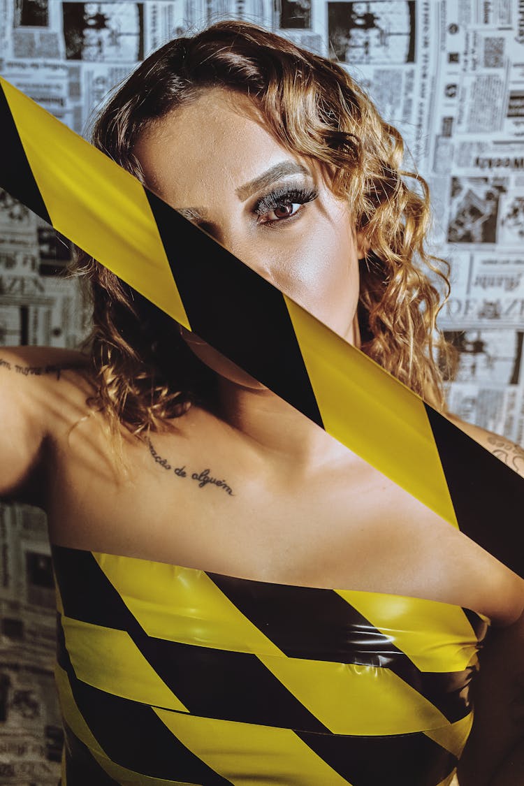 Woman Wrapped In Black And Yellow Tape 