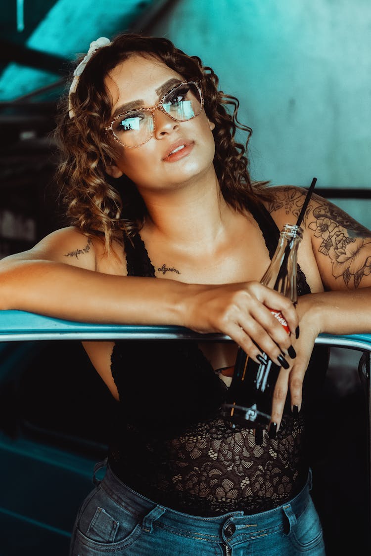 Portrait Of Beautiful Woman Drinking Coke And Wearing Sunglasses