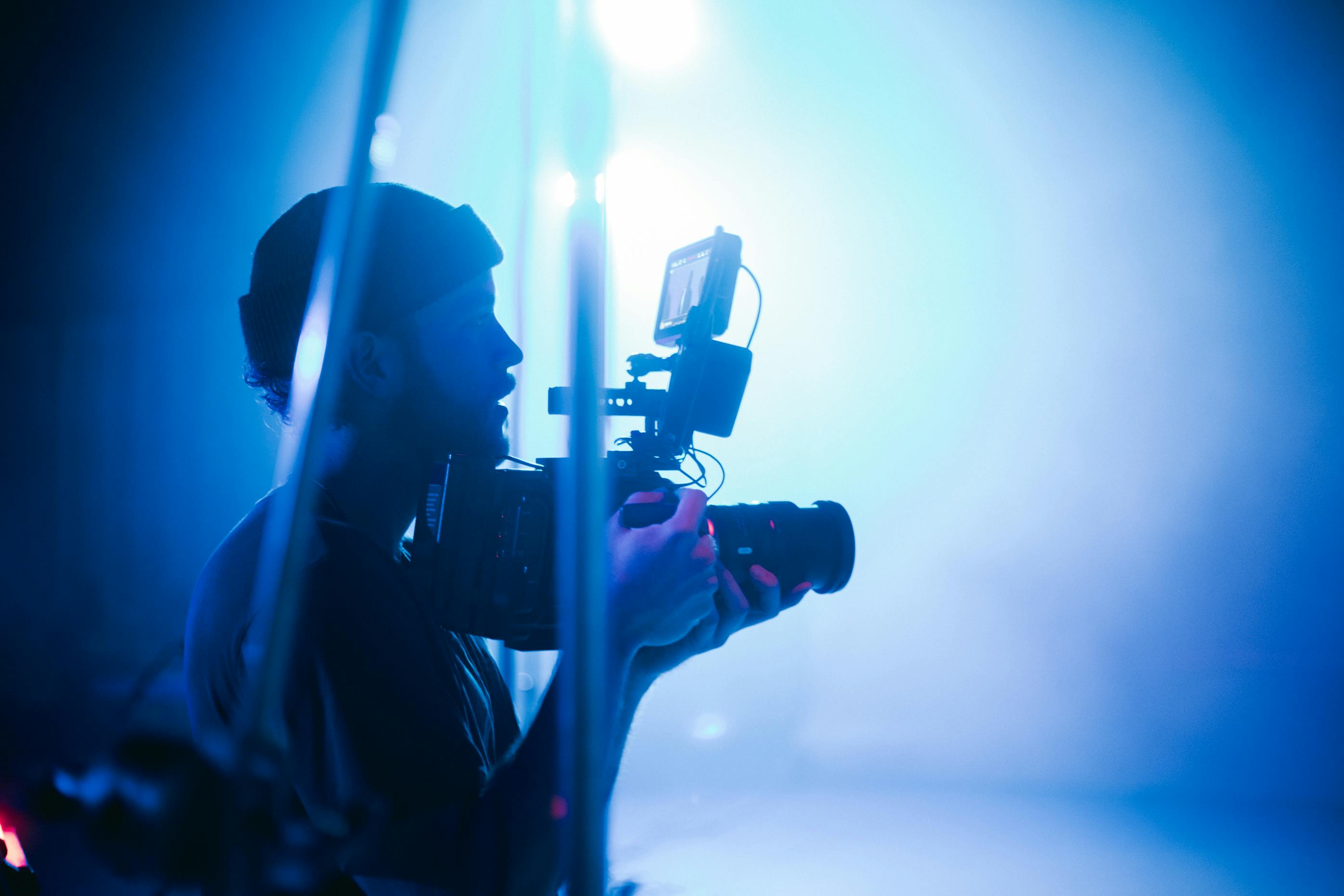 silhouette of man holding camera