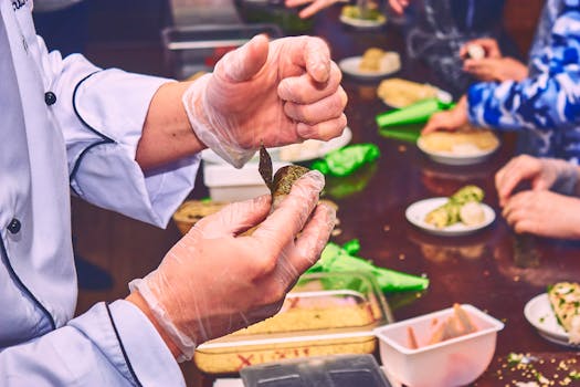Close-up of a chef demonstrating finger food preparation in a culinary class setting.