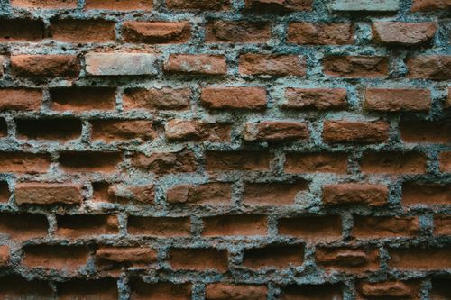 Free Detailed texture of a weathered red brick wall with mortar. Stock Photo