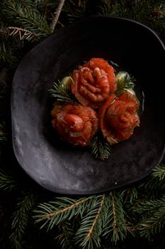 Artistic presentation of salmon roses on a black plate, perfect for gourmet food lovers.