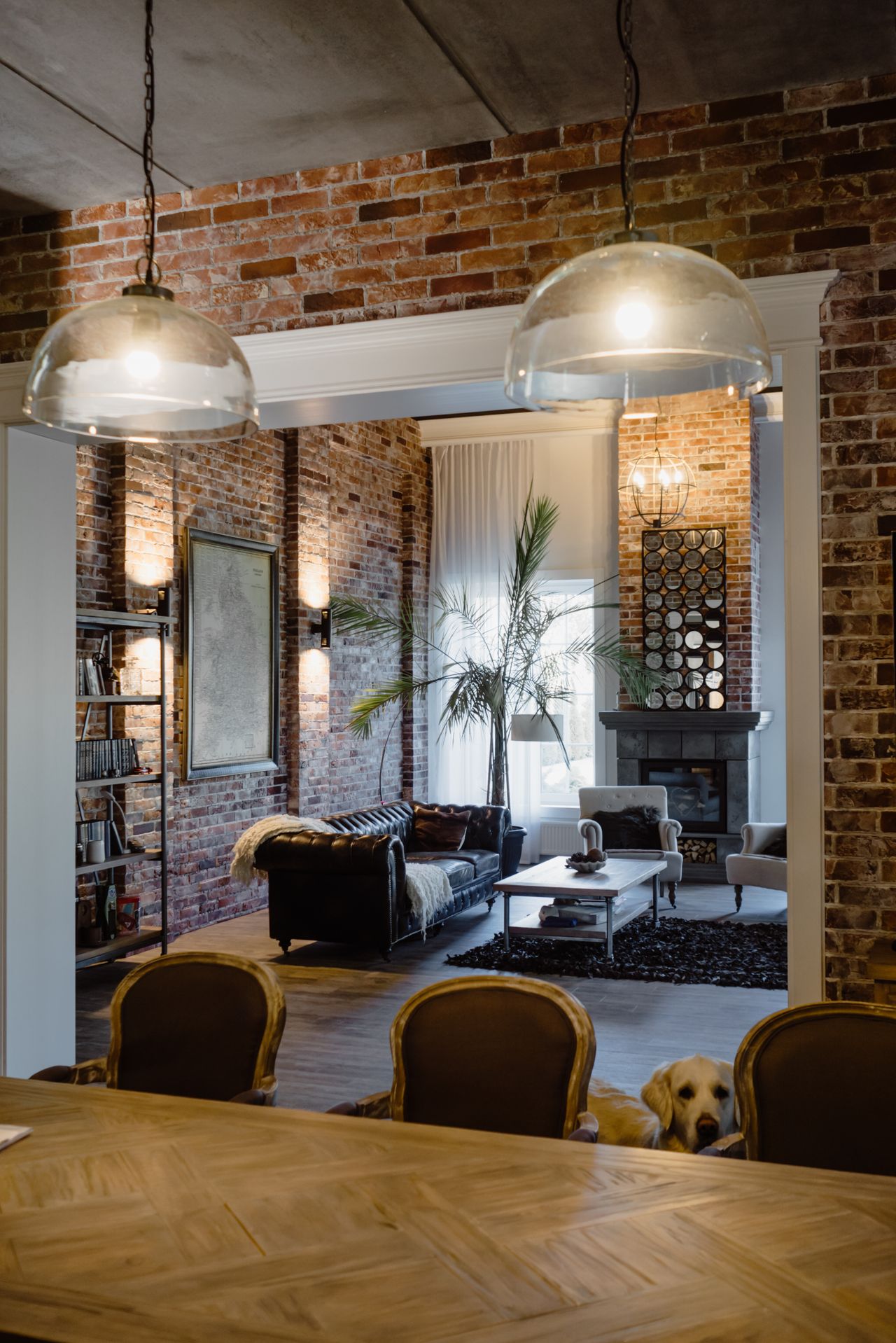 Brick loft living room with glass pendant lights and leather sofa