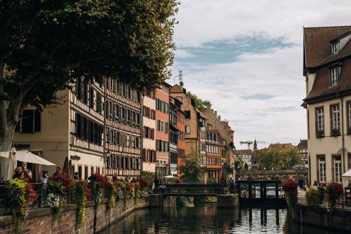 Free Exterior of aged city with embankment of river and classic buildings near park Stock Photo