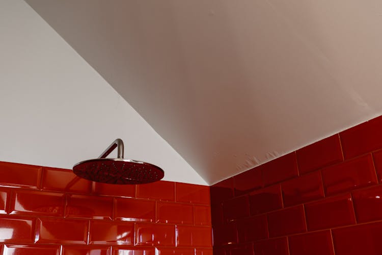 A Round Shower Head On The Red Brick Wall 