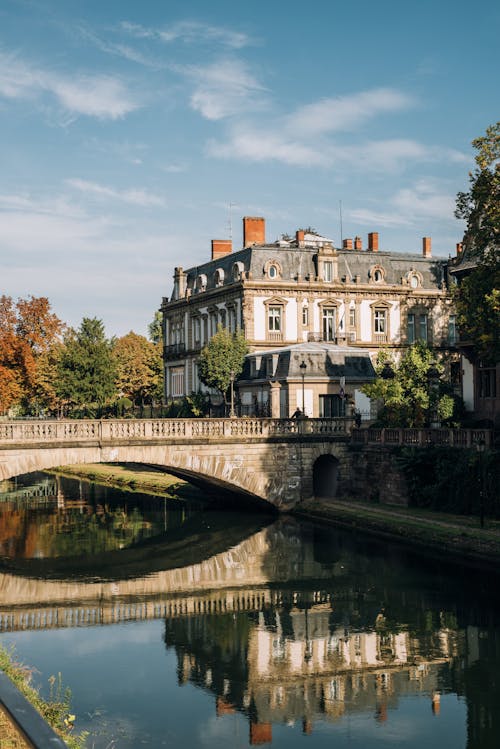 Classic building near stone bridge over river