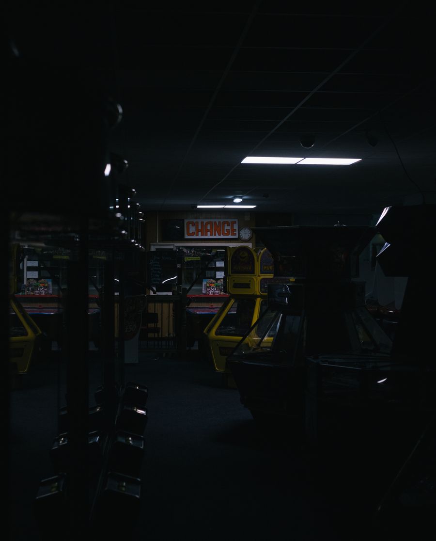 Arcade machines glowing in a games hall