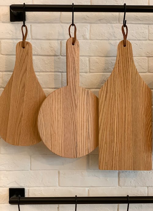 Free Decorative Wooden Cutting Boards Hanging in Kitchen Stock Photo