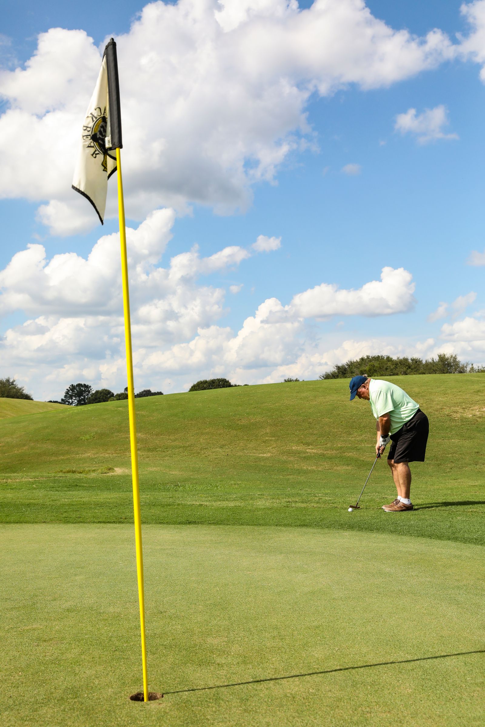 Player holing a putt during a team challenge
