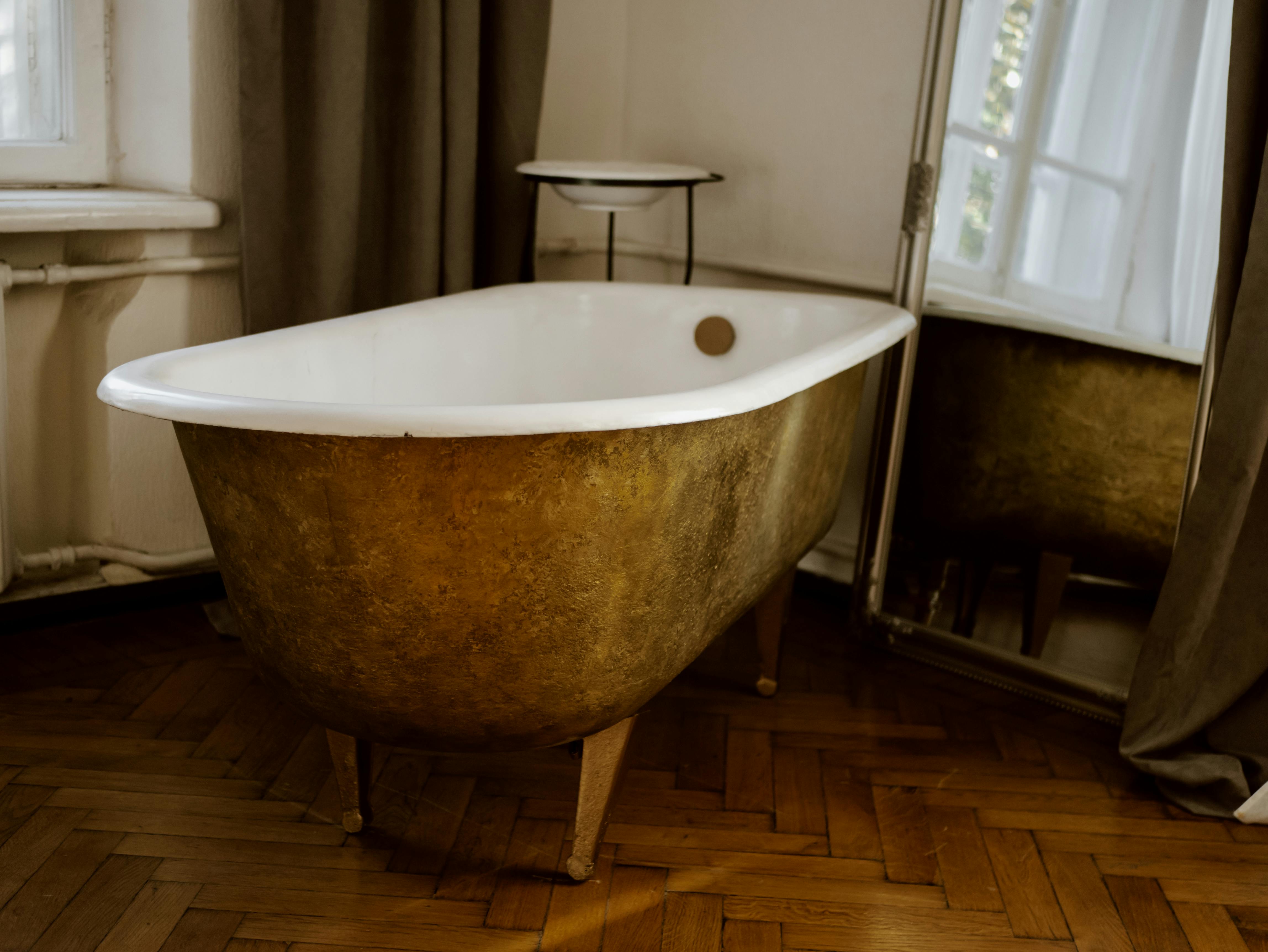 white ceramic bathtub near gray curtain