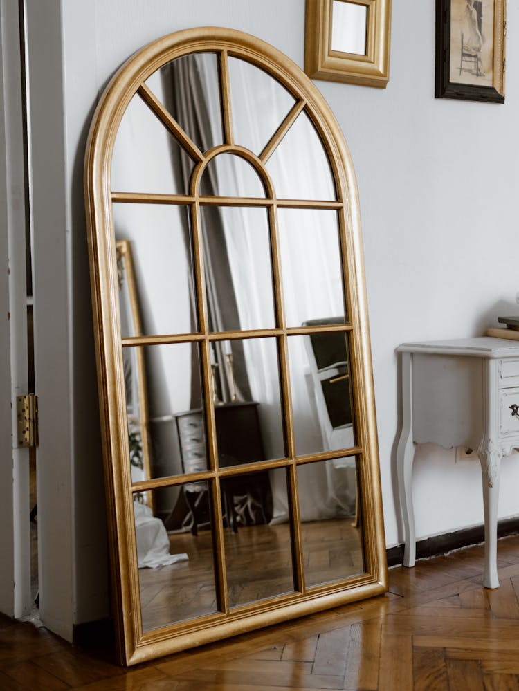 Arched Wooden Framed Mirror On The Wall