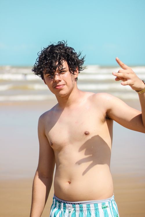 Free Casual portrait of a young man with wet hair enjoying a day at the beach. Stock Photo