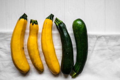 Yellow and Green Vegetable on White Wooden Table