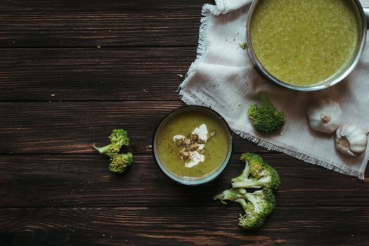 A rustic presentation of healthy homemade broccoli soup in bowls.