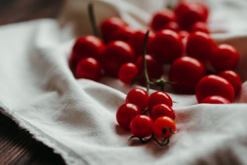 Close-Up Shot of Fresh Cherry Tomatoes on White Textile