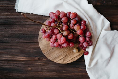 Free Grapes on Round Wooden Board Stock Photo
