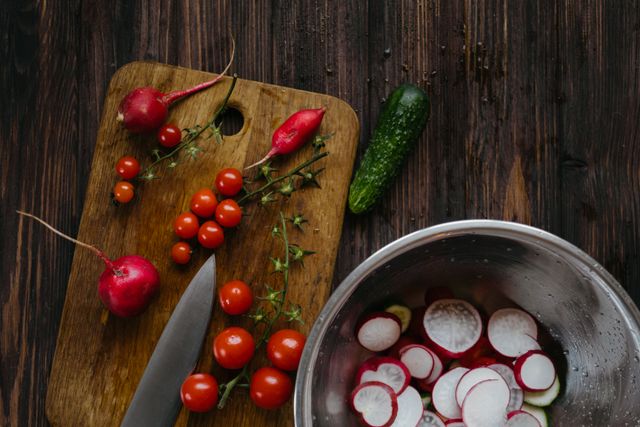 Fresh vegetables including tomatoes on a chopping board