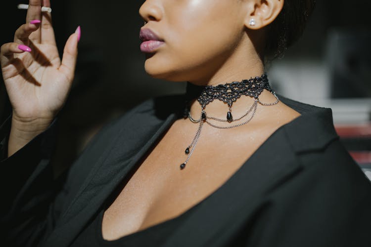 Woman In Black V Neck Top Wearing Silver Necklace