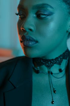 Close-up shot of a stylish woman featuring detailed makeup and a unique choker necklace.