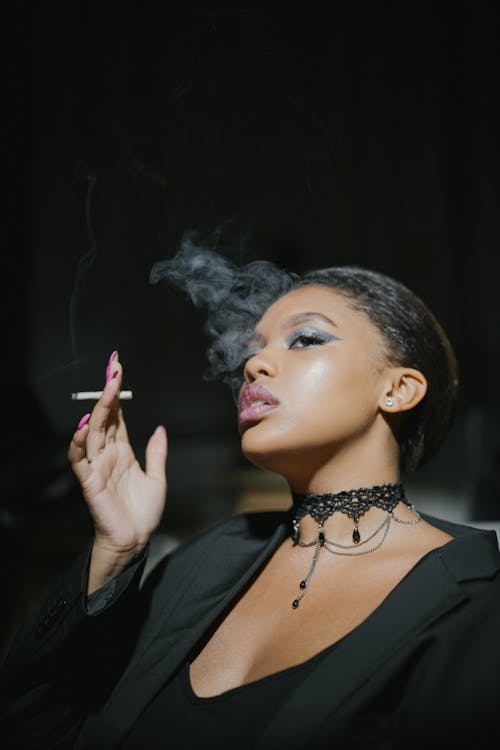 Woman in Black Clothing Smoking Cigarette