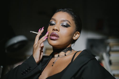 Free Woman in Black Blazer Holding Cigarette Stick Stock Photo
