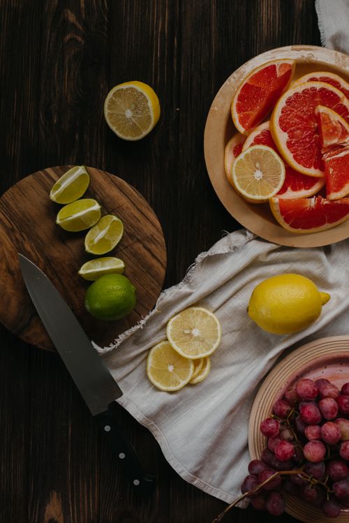 Free A top-down view of assorted citrus fruits and grapes on a wooden table for a healthy diet. Stock Photo