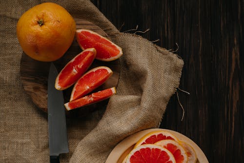 Sliced Orange Fruit on Brown Textile