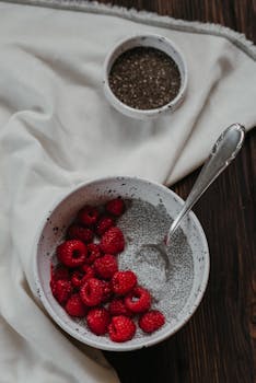Chia pudding topped with juicy raspberries in a rustic bowl, perfect for a healthy breakfast.