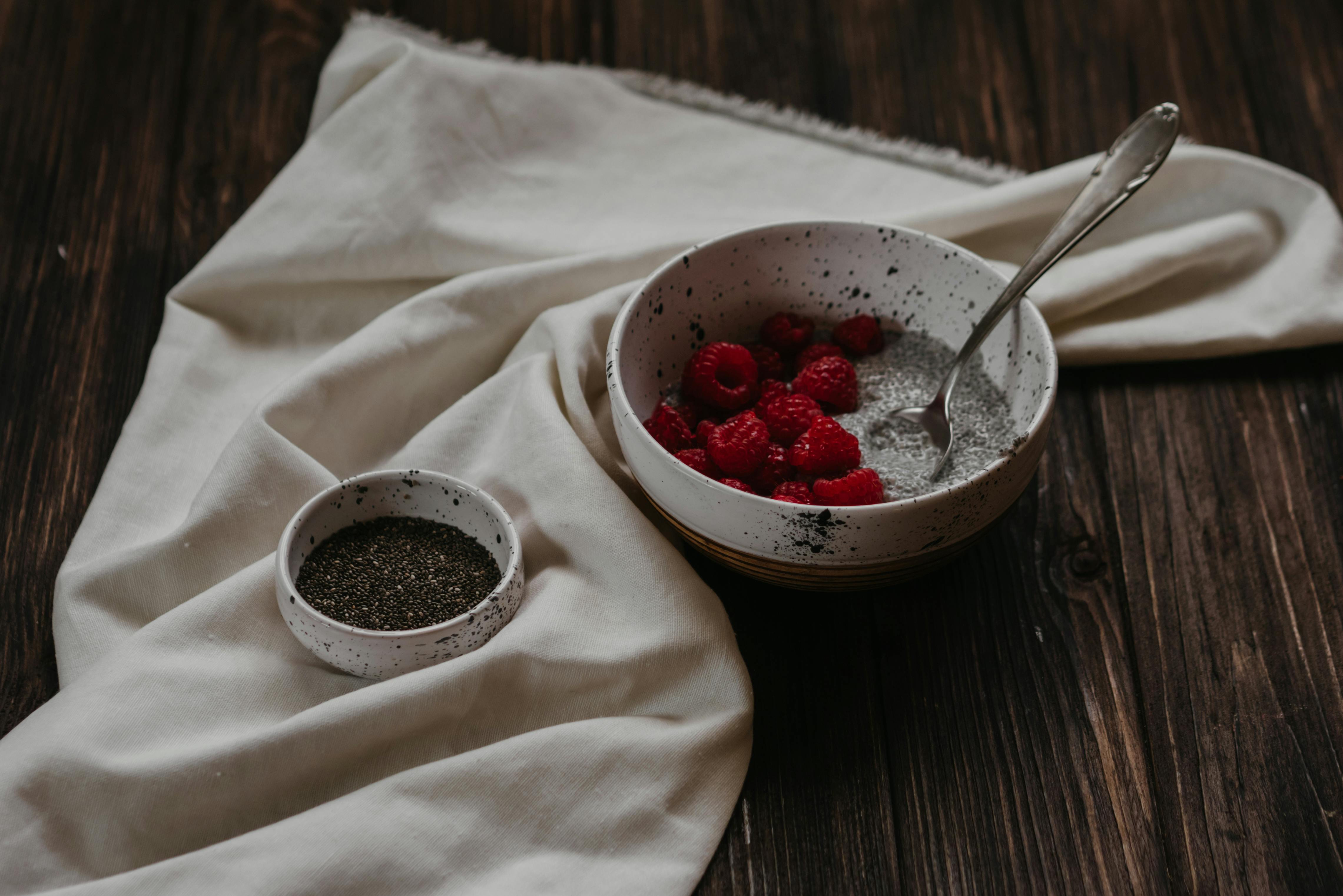 raspberry in white ceramic bowl