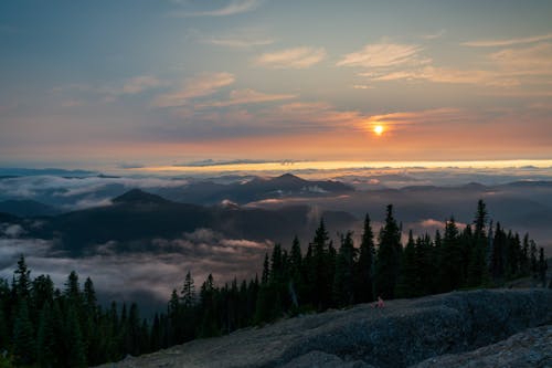 Sunset over Mountains Covered with Fog