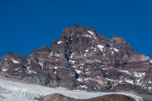 Free A stunning rocky mountain peak capped with snow under a clear blue sky. Stock Photo