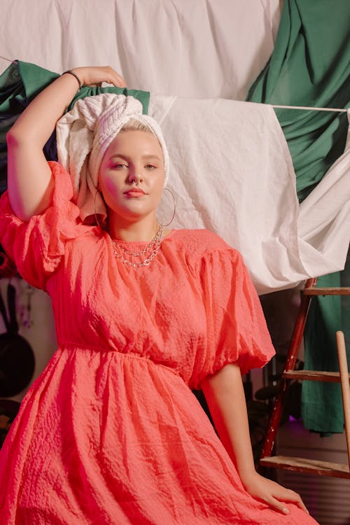 A Woman Posing Near the Hanging Blanket 