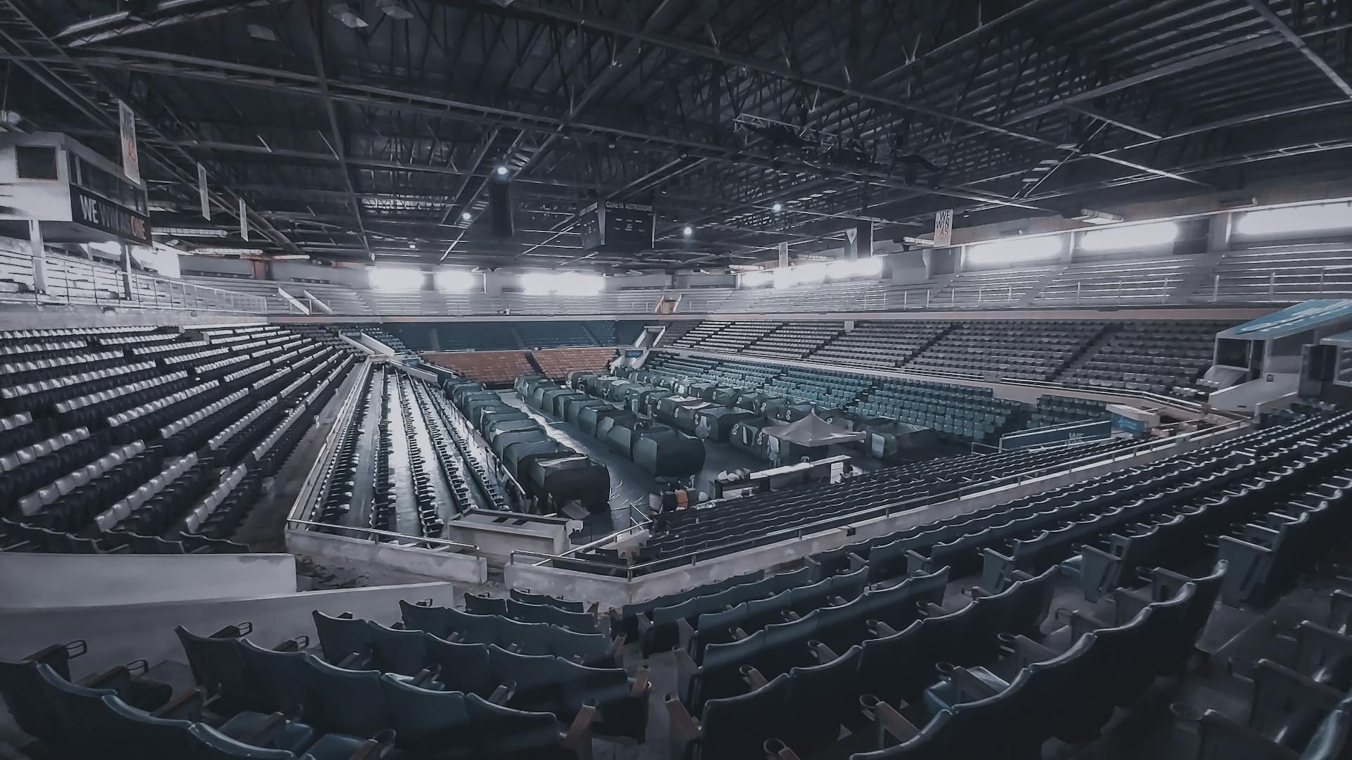 An empty stadium interior showcasing rows of seats and dramatic lighting.