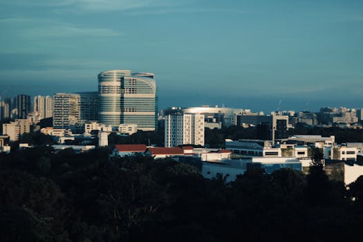 Skyline of Singapore featuring modern architecture under a clear blue sky.